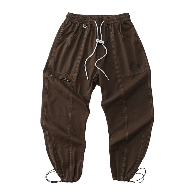 Brown gothic cargo harem pants flat lay showcasing dropped crotch design and zippered side pocket functional detail