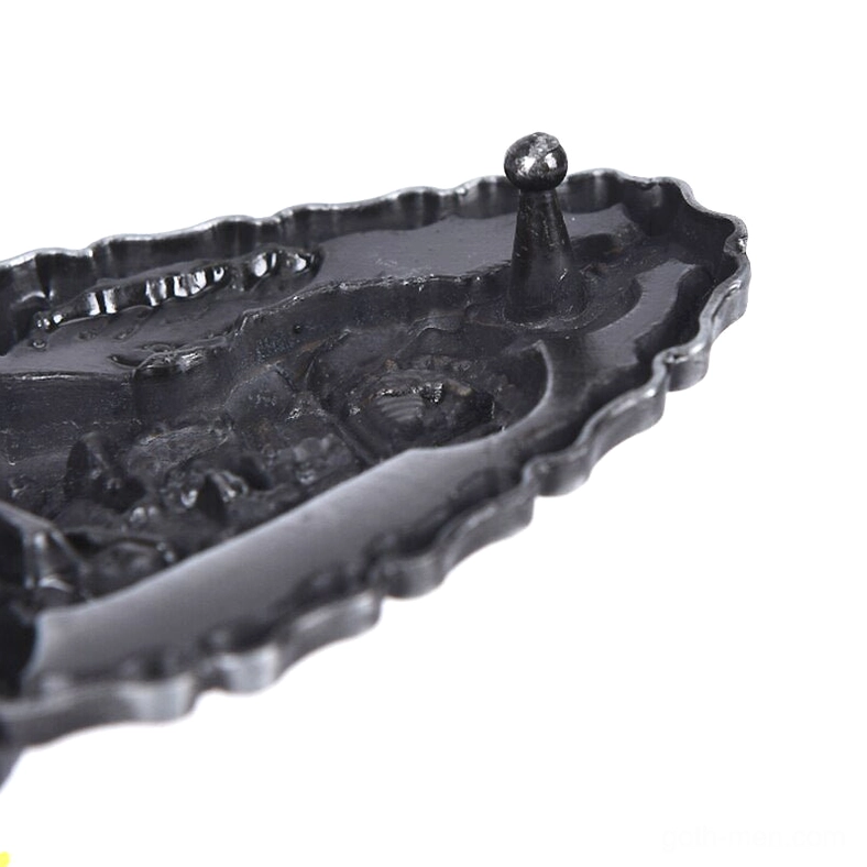 Extreme close-up of chain-style border and recessed rear structure of the metal belt buckle, showcasing craftsmanship detail