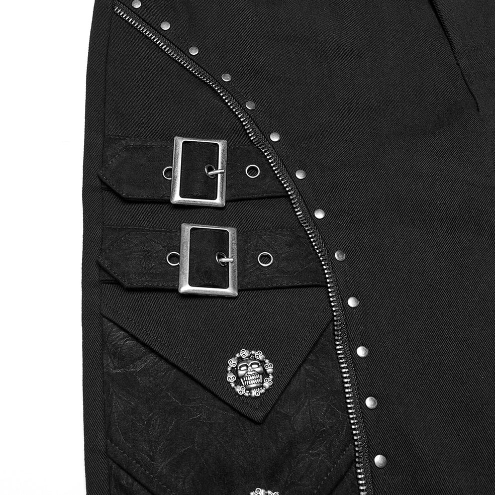 Close-up detail of silver metal buckle straps zipper trim and embossed skull button on black twill