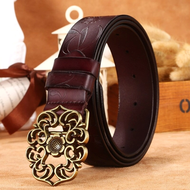 Burgundy leather gothic waistbelt with embossed floral details and ornate bronze pin buckle, three-quarter view