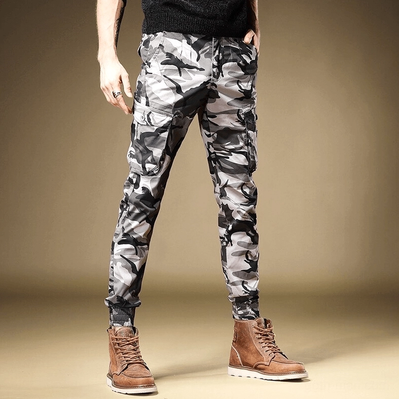 Camouflage cargo pants side view showing elastic ankle cuff detail and slim tapered fit on male model