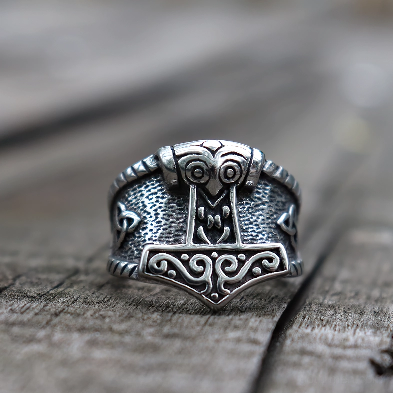 Celtic trinity knot ring detail - intricate scrollwork on hammer face and Nordic engravings on stainless steel