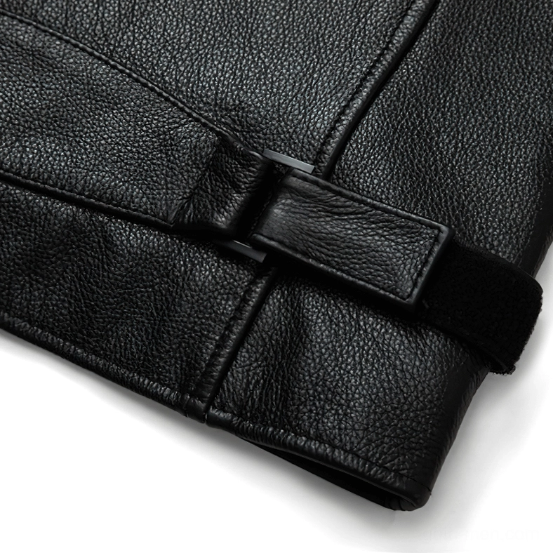 Sleeve cuff adjustment system showing velcro and snap fasteners on black leather jacket