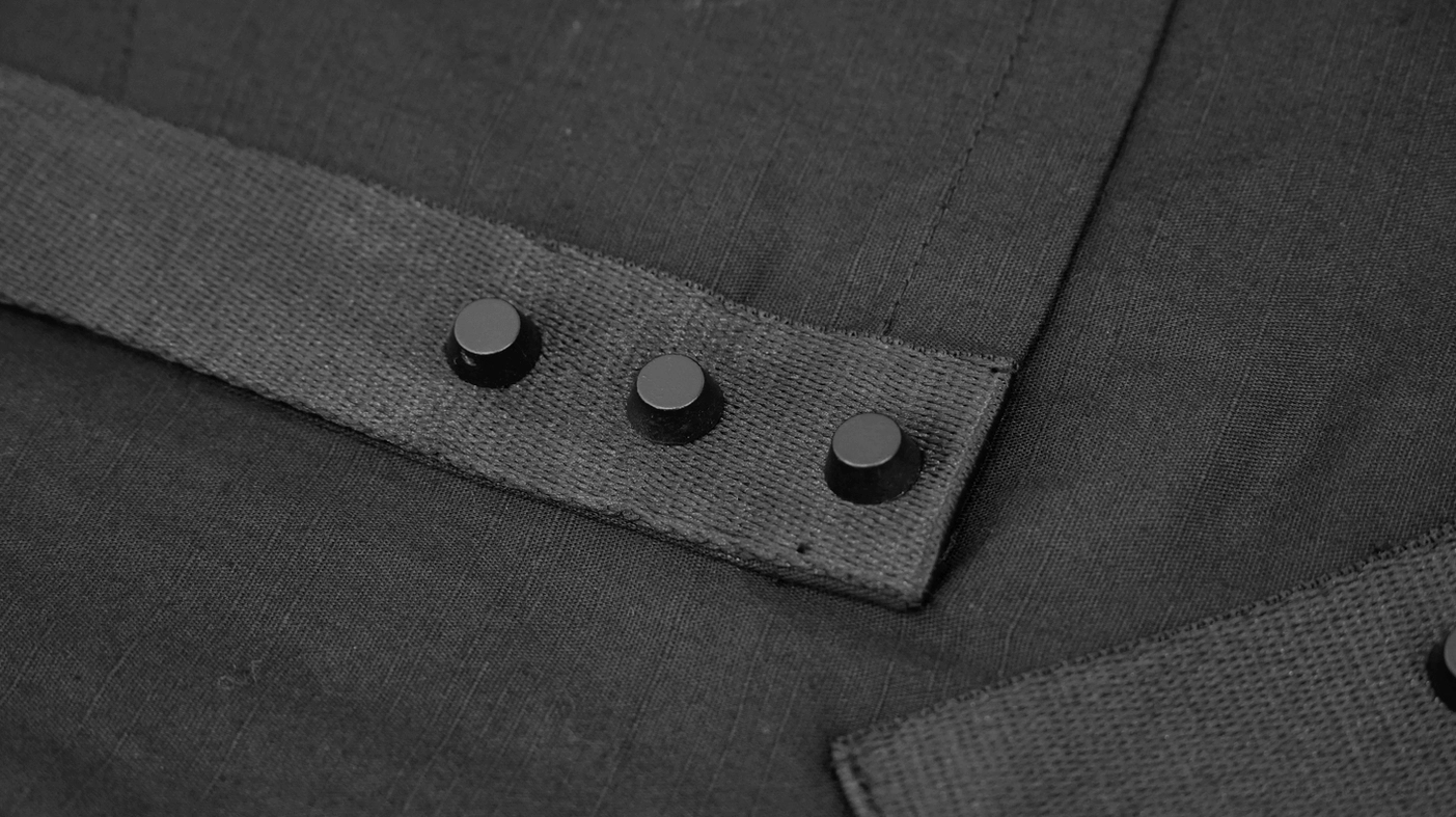 Gothic cyberpunk tactical shirt fabric texture and weave quality close-up in studio lighting