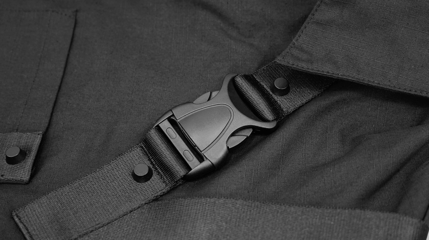 Black cyberpunk tactical harness shirt shoulder strap system architectural detail close-up
