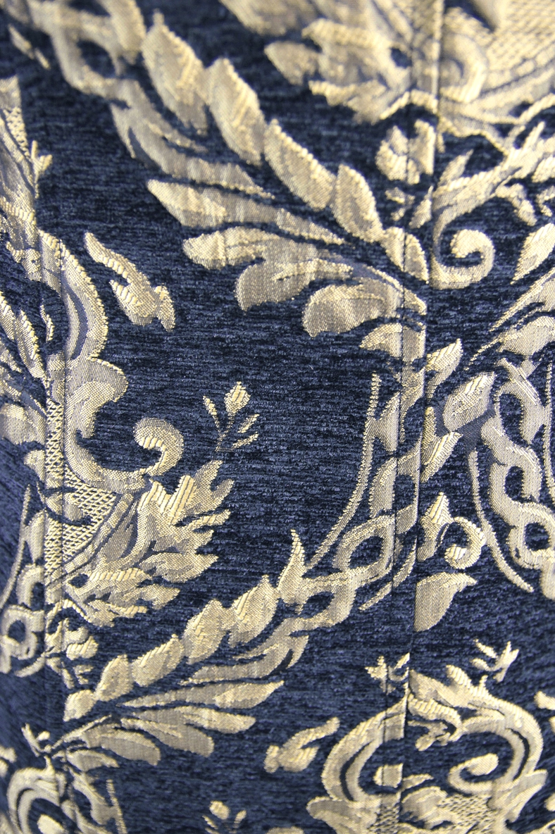 Intricate gold leaf scroll damask fabric texture on dark woven polyester gothic coat