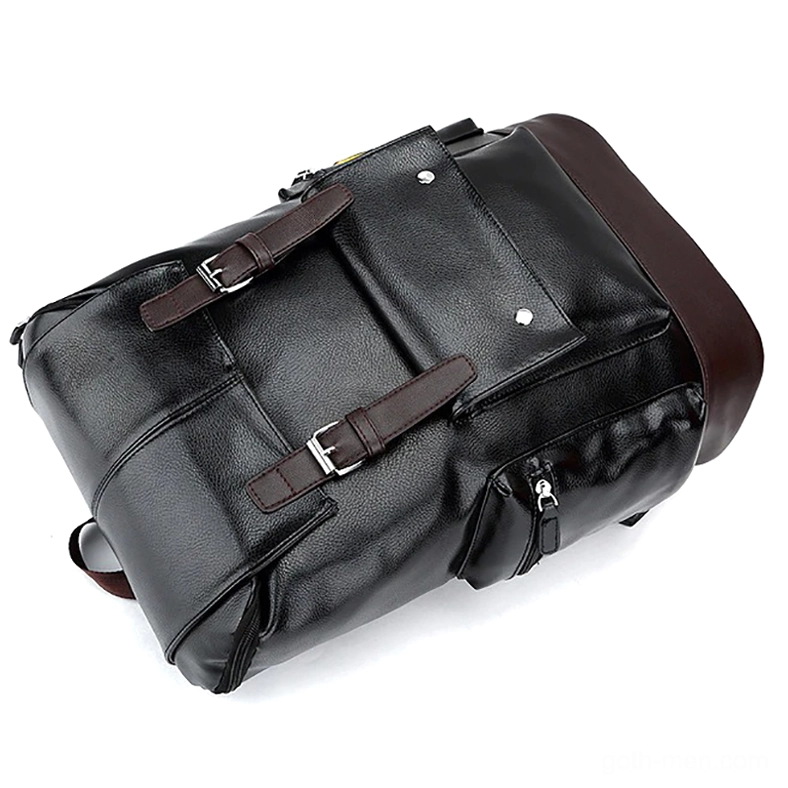 Black PU leather backpack side angle view showing top carry handle, dual buckle straps, and multi-pocket design