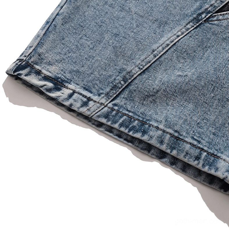 Hem and side seam detail of light blue denim shorts showcasing tailored construction and denim texture quality