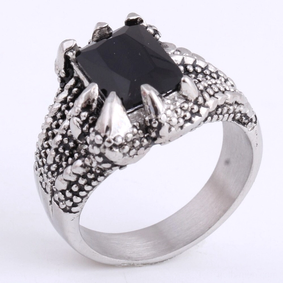 Top-down view of dragon claw ring displaying sharp metal claws framing black onyx and textured band details
