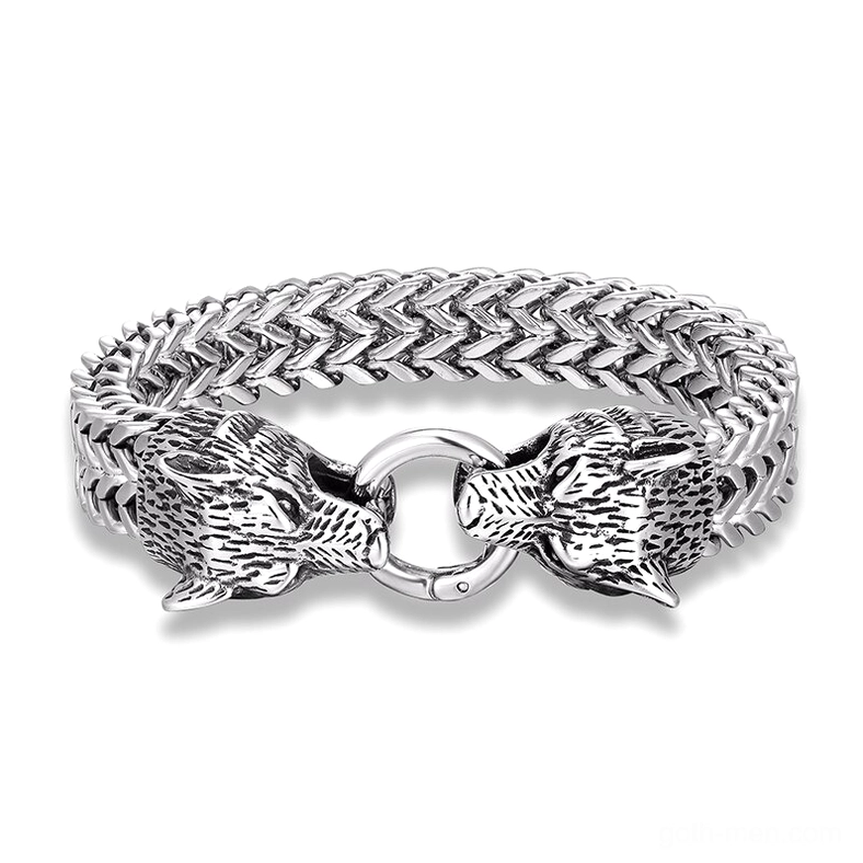 Dual wolf head stainless steel gothic bracelet with wheat link chain, polished silver finish, flat lay top-down view on white background