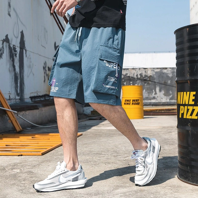 Dusty blue cargo shorts highlighting fabric texture and drawstring waist design