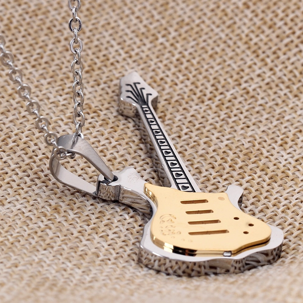 Three-dimensional overhead view of bicolor guitar pendant with engraved neck patterns on linen texture background