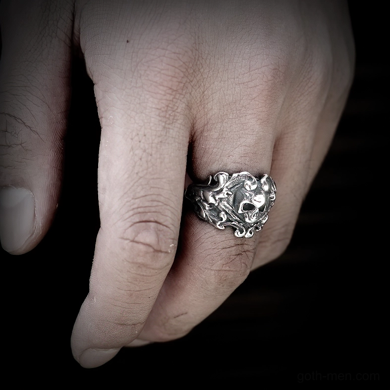 Embossed skull biker ring male model hand dark studio close-up gothic statement jewelry