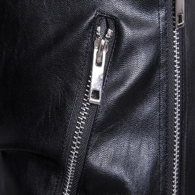 Extreme close-up of dual metal zippers and pebbled faux leather texture detail