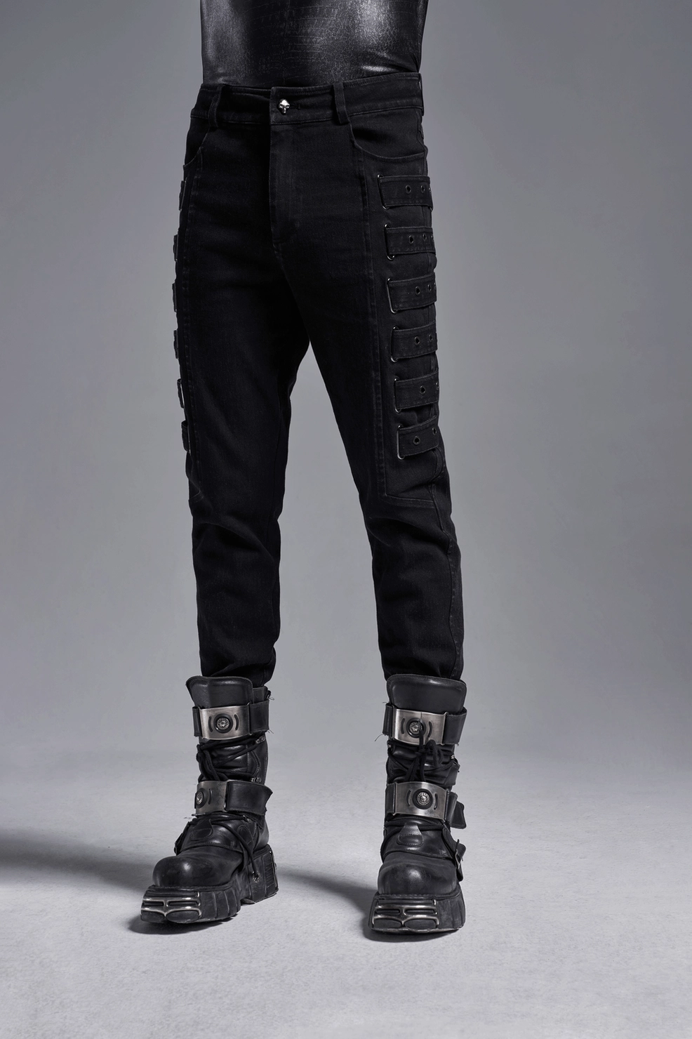 Fitted black cargo trousers featuring industrial-inspired side straps and modern tailored proportions