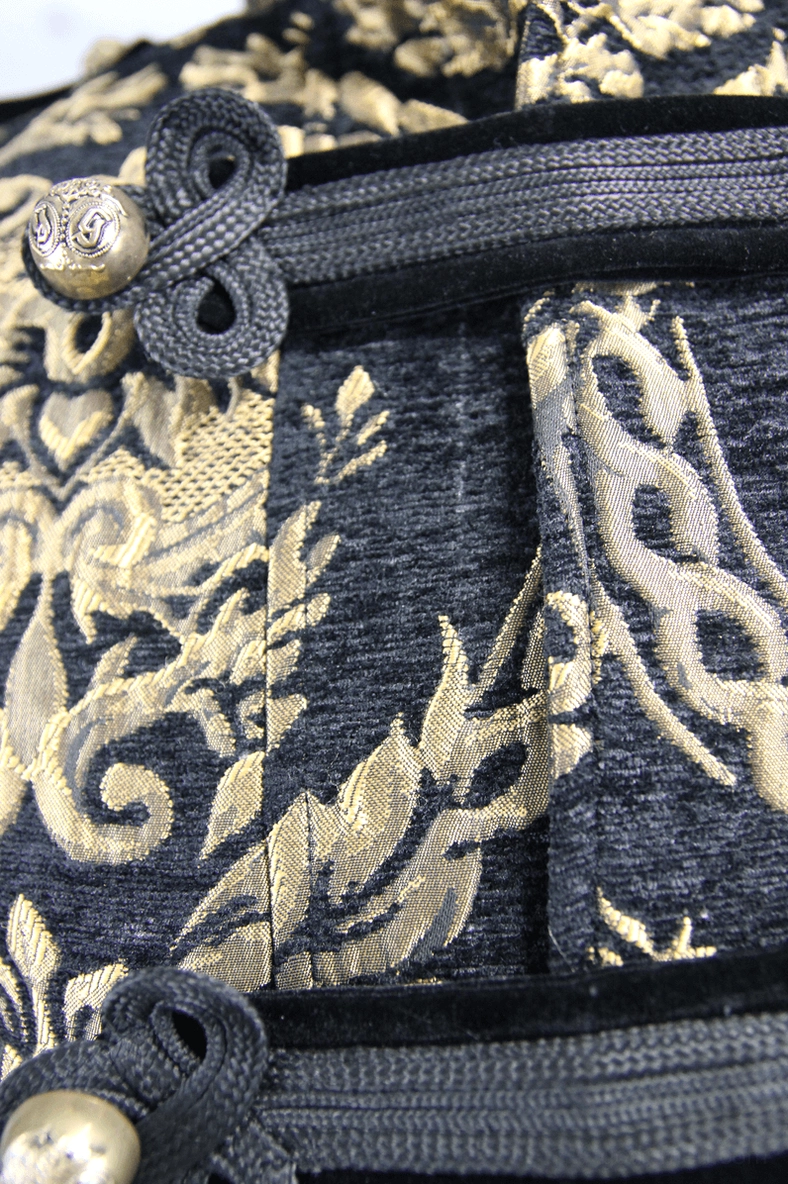 Ornamental frog closure detail with metal decorative knob on men's gothic embroidered coat