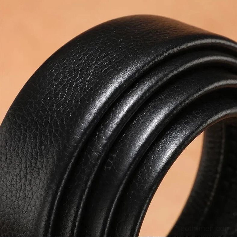 Close-up detail of black lychee grain genuine leather texture on gothic belt strap