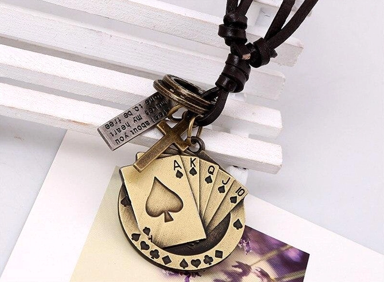 Gold-toned poker cross leather necklace with spade royal flush design close-up detail view