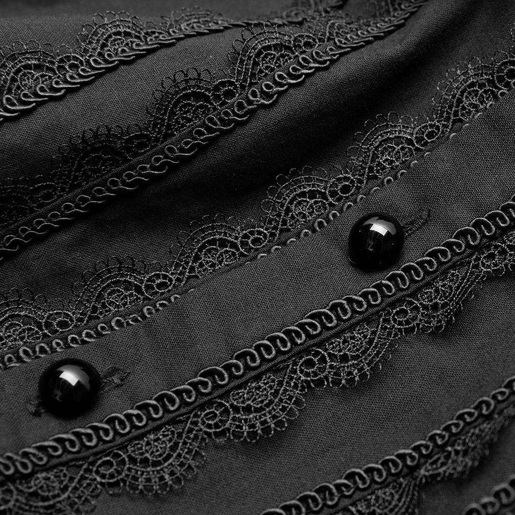 Close-up detail of Victorian gothic shirt front trim showing scroll lace and black buttons