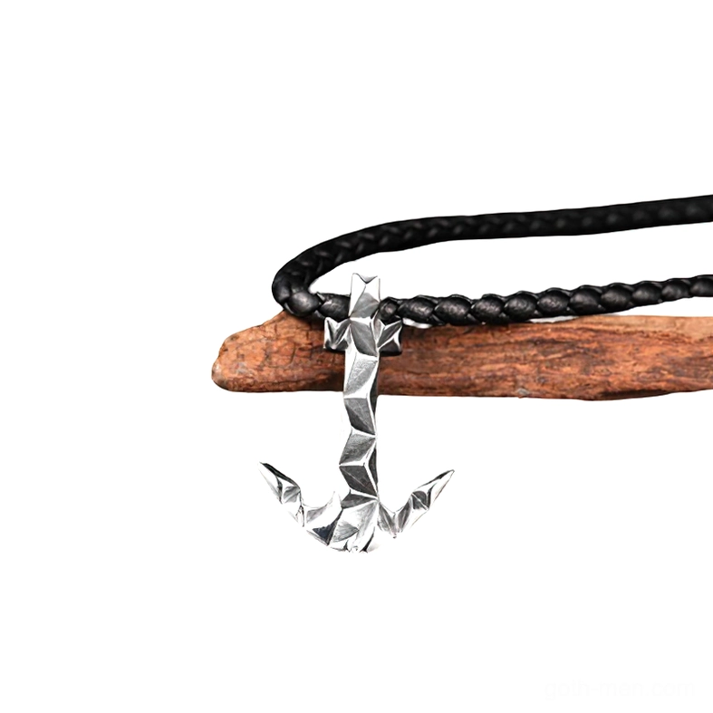 Compact faceted anchor pendant in bright stainless steel attached to black braided cord, side perspective on white background