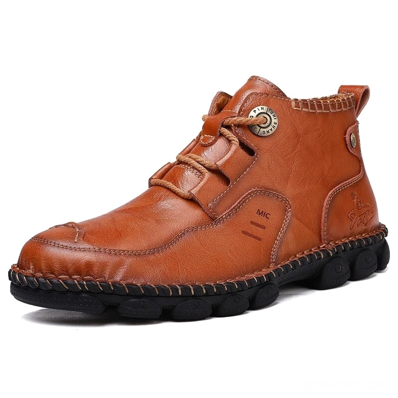 Tan men's gothic ankle boots profile view - side embossed text detail on split leather boot