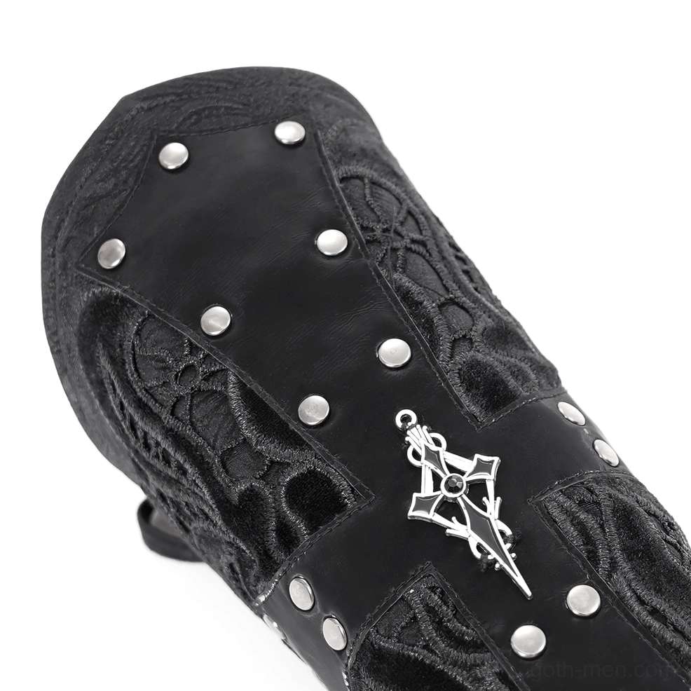 Close-up top-down view of gothic arm guard showing metal rivets, cross pendant, and textured fabric construction