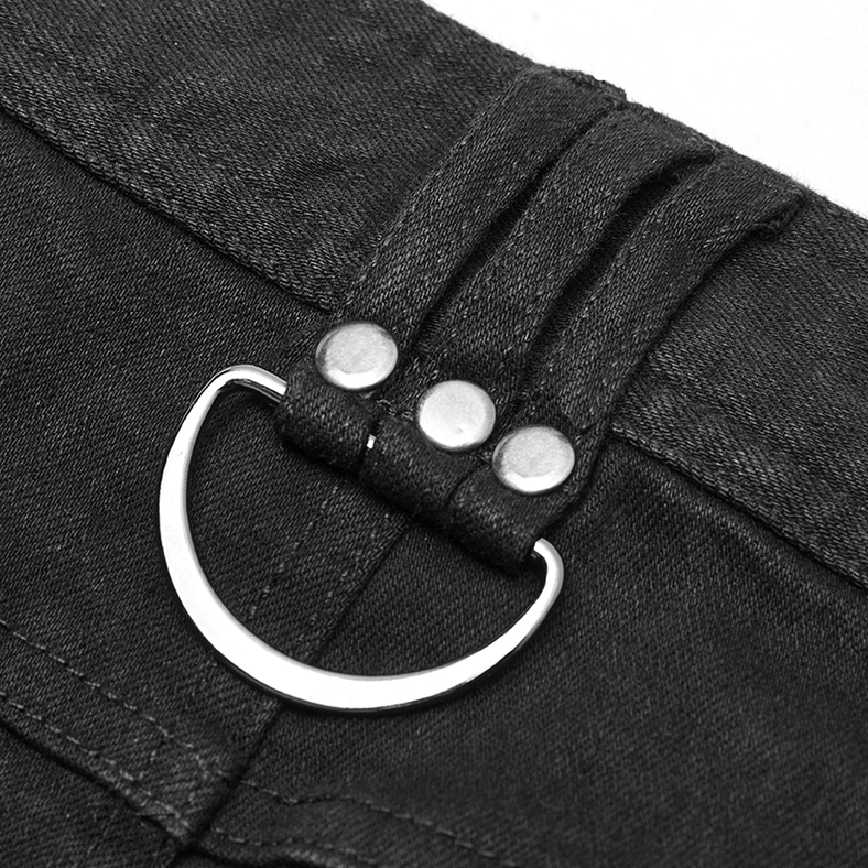 Close-up macro detail of metal D-ring and dual rivet fasteners on gothic armor jeans