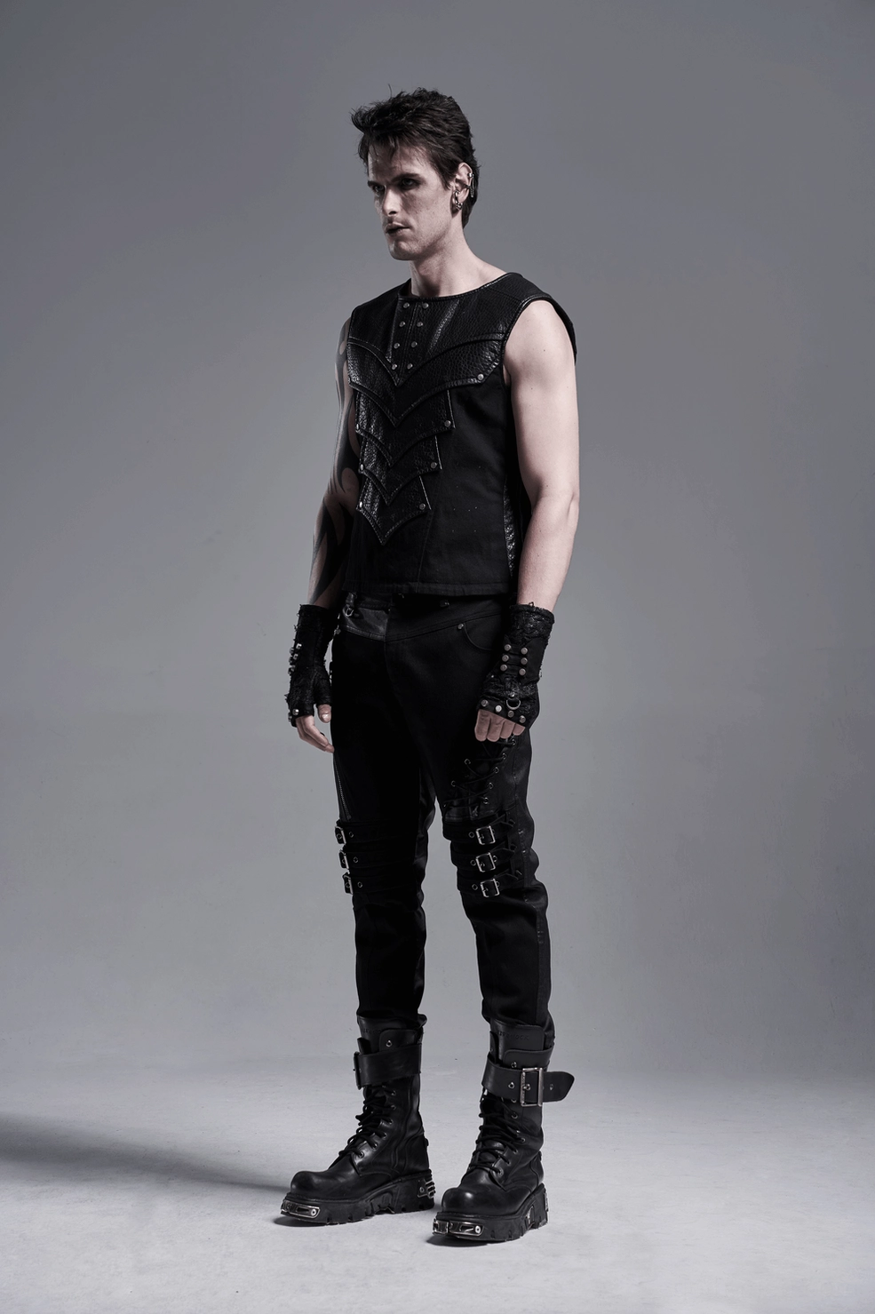 Black gothic armor vest worn look showing fitted silhouette and chevron panel positioning
