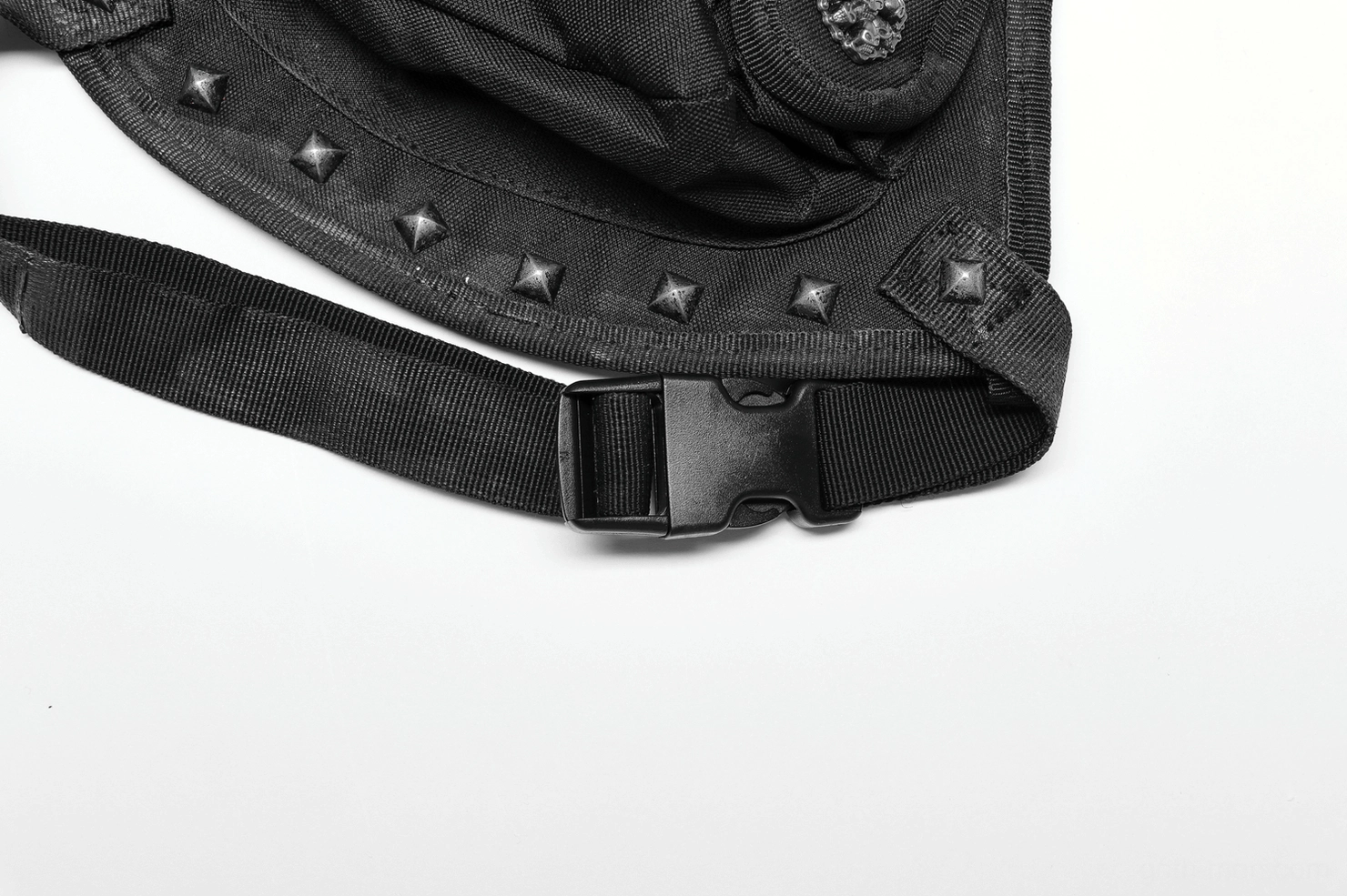 Close-up of gothic bag webbing strap with plastic buckle fastener, studded trim, and adjustable attachment system