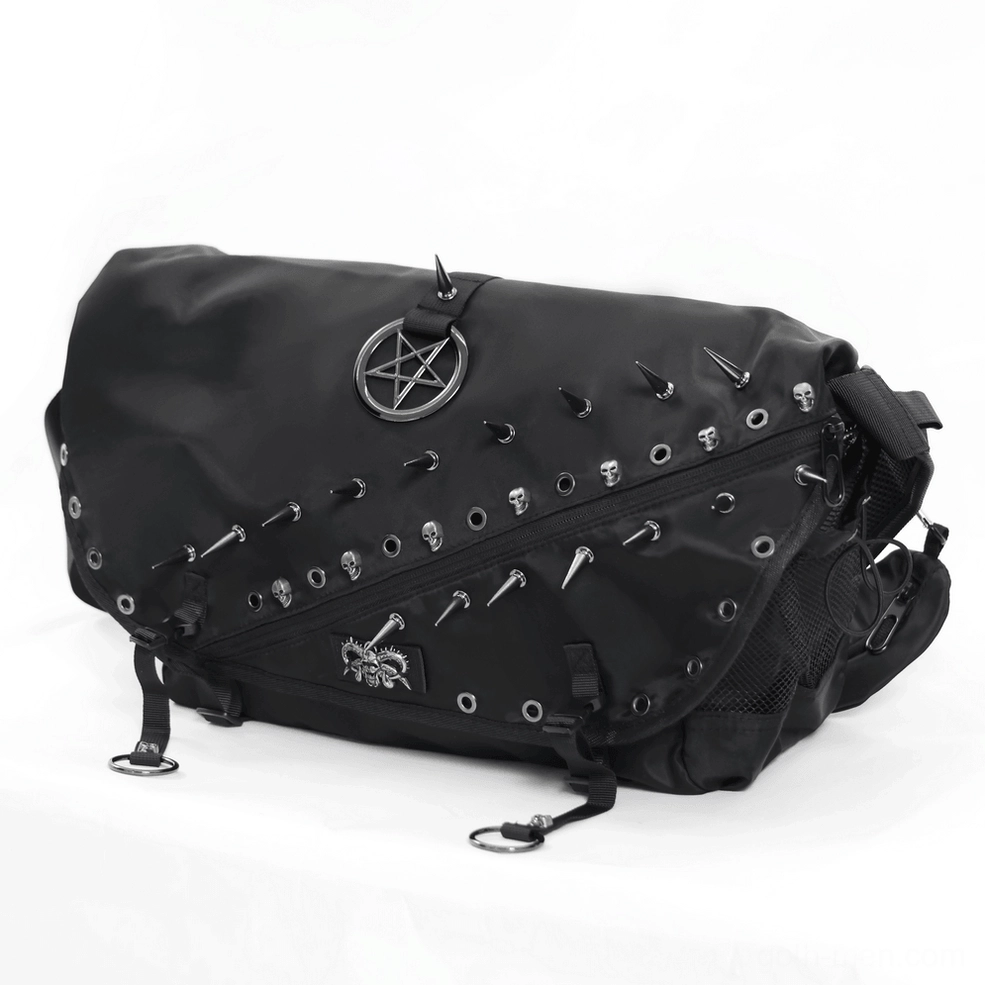 Close-up front detail of black gothic bag featuring spike studs, pentagram charm, and skull accents with metal hardware