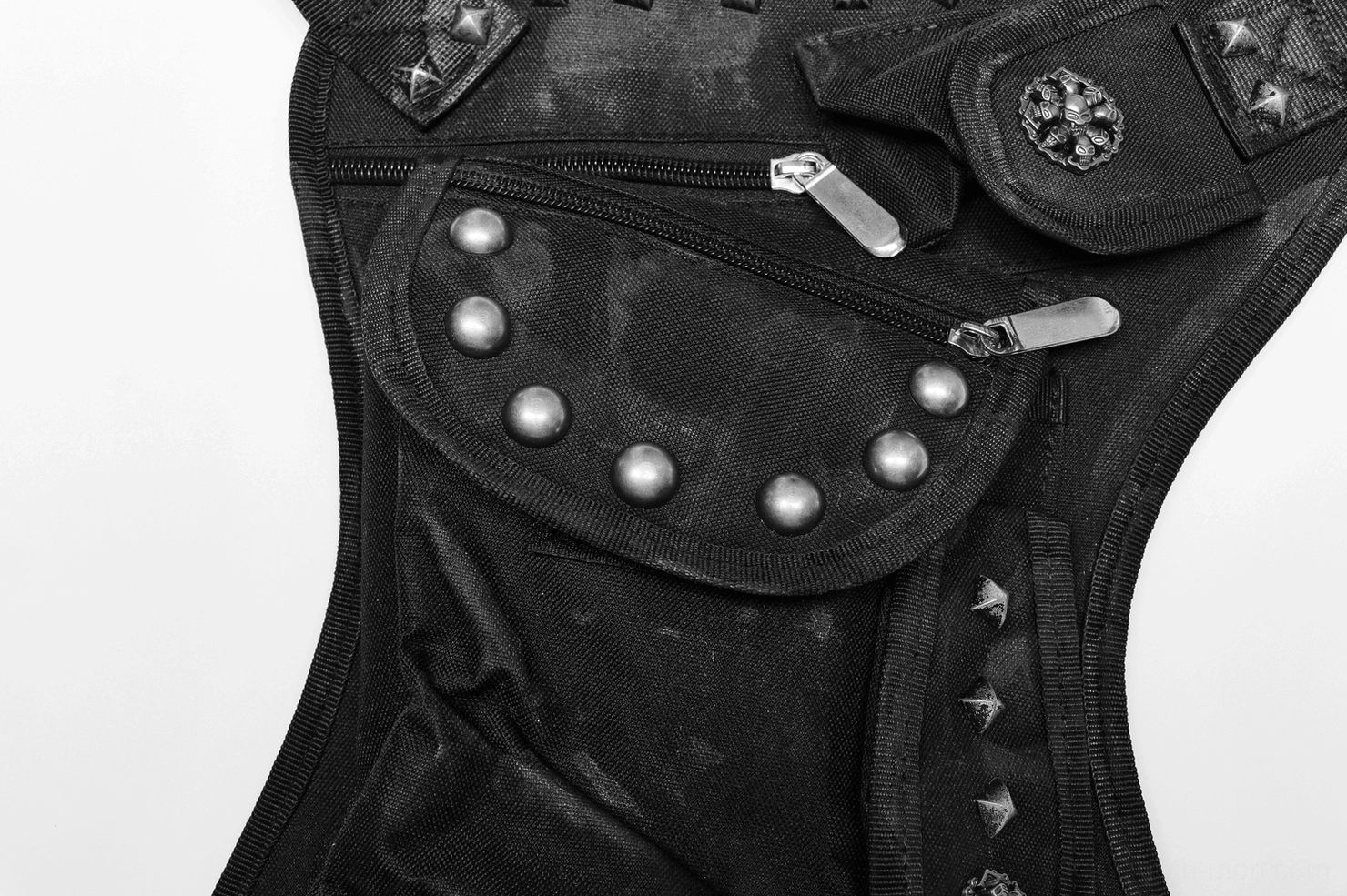 Detailed close-up of black gothic bag zippered pocket with round metal studs and reinforced stitching