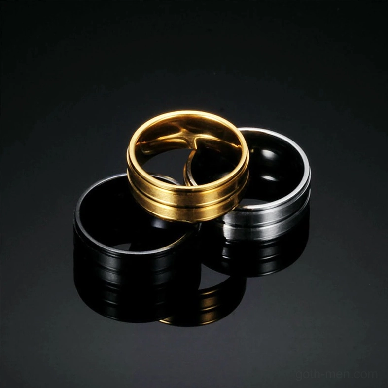 Three-piece gothic band ring set stacked in triangular formation on glossy black reflective background