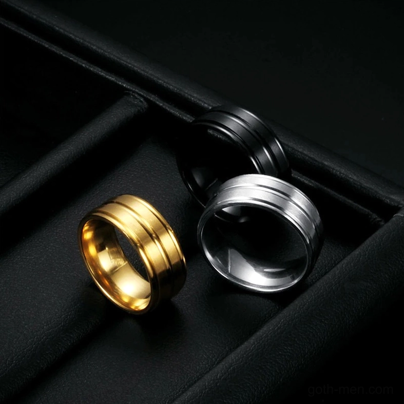 Three gothic minimalist band rings displayed on black leather jewelry tray, alternative fashion accessories