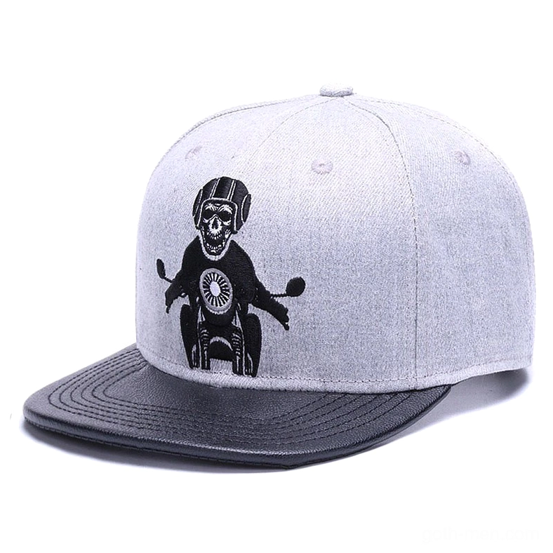 Three-quarter front angle of gothic snapback cap showing helmet-wearing skeleton on motorcycle embroidery