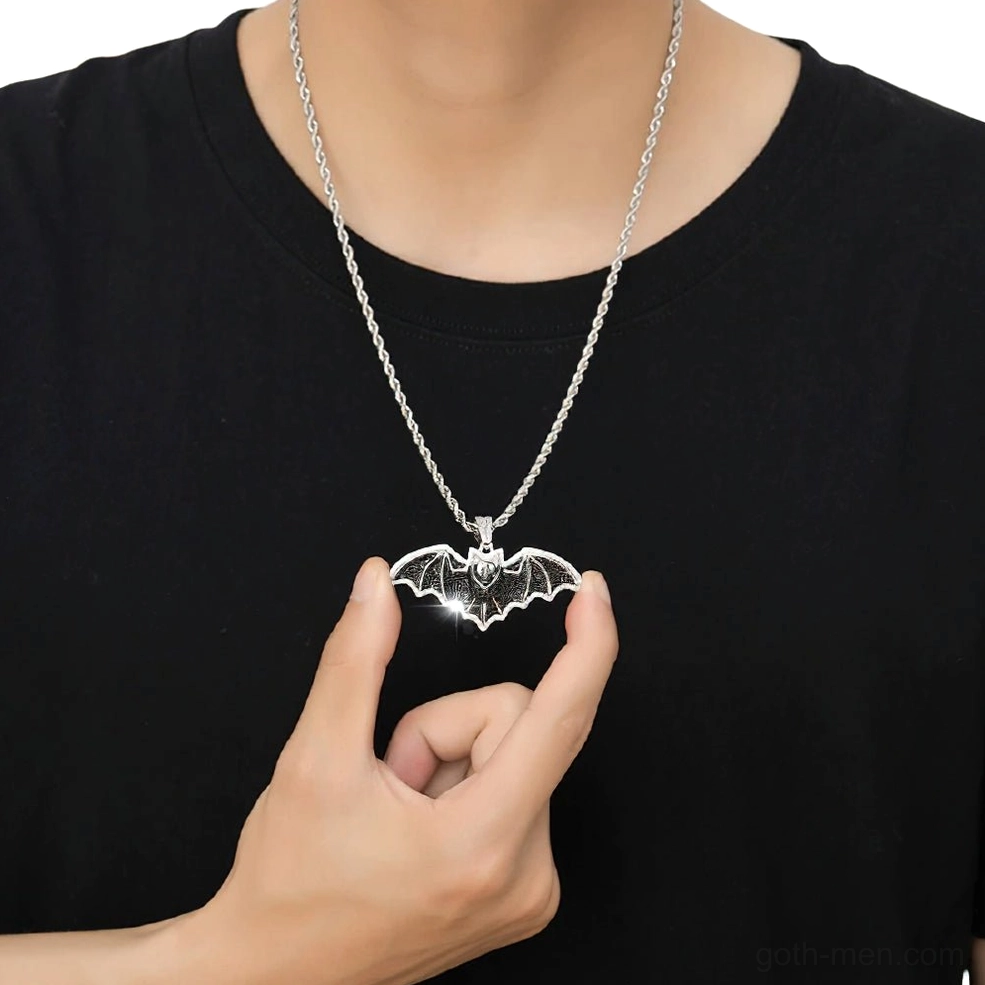 Gothic bat pendant necklace worn on twist silver chain, male model wearing on chest with black casual shirt