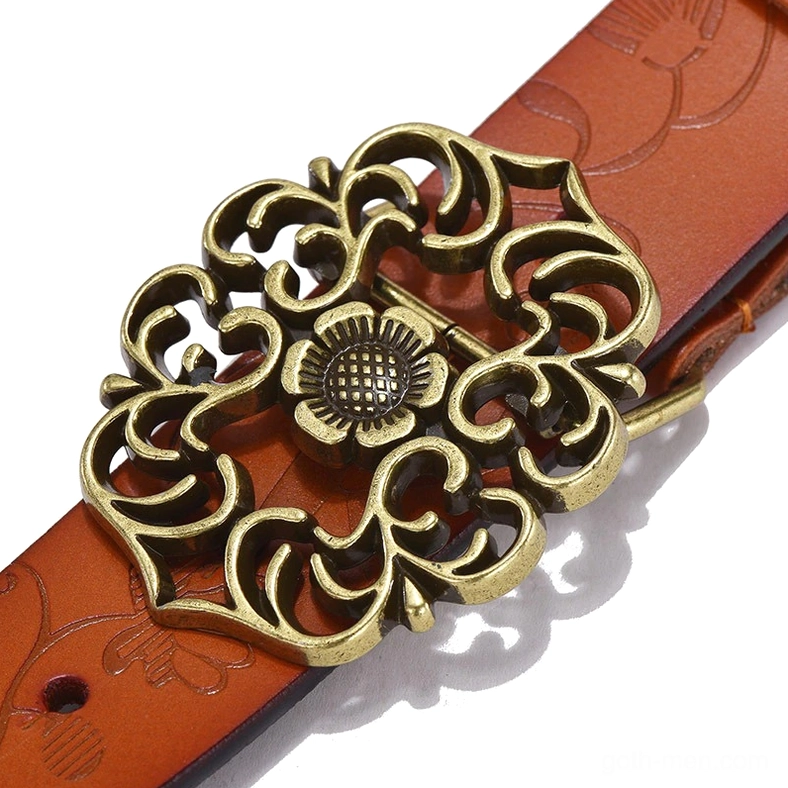 Close-up detail of embossed leather strap and ornate bronze flower pin buckle on gothic women's belt