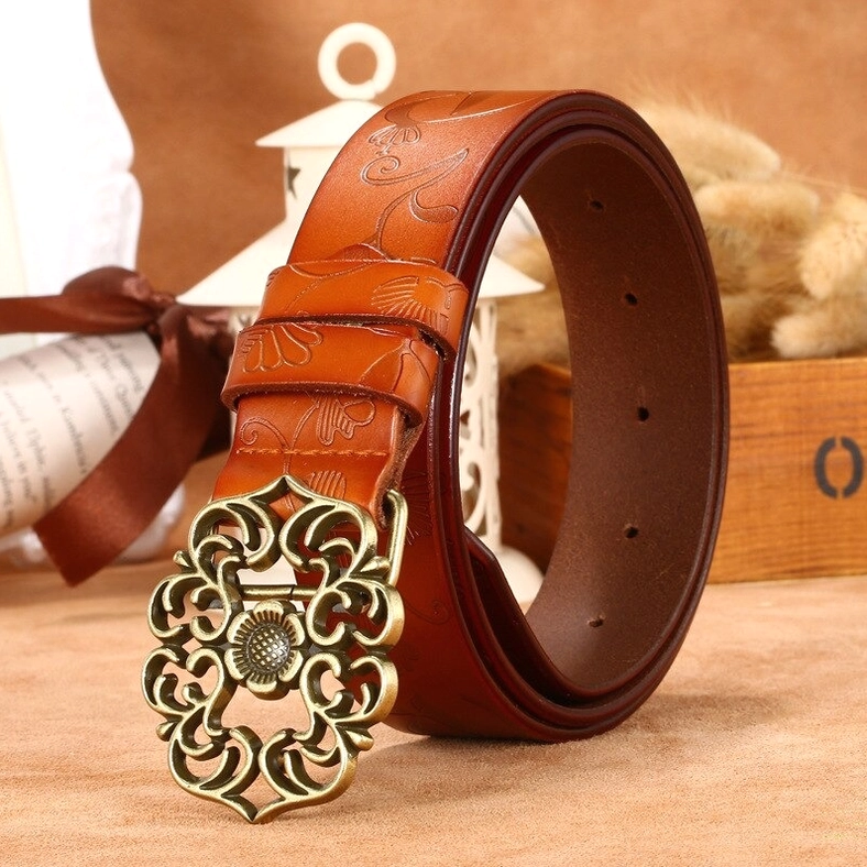 Gothic embossed leather women's belt collection detail shot showing texture and ornate metal buckle craftsmanship