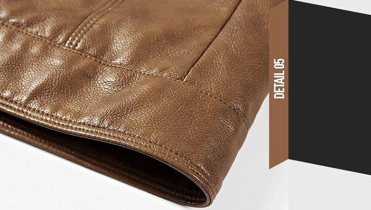 Close-up of gothic moto jacket hem and seam stitching detail in brown faux leather material