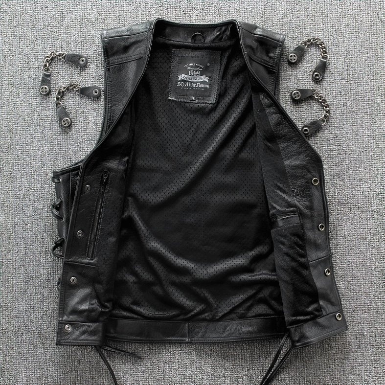 Top-down view of black leather gothic vest showing mesh lining and metal hardware