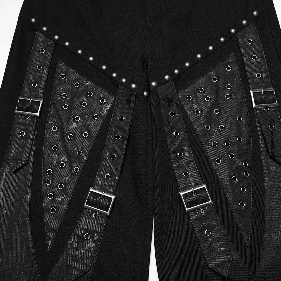 Black gothic pants front panel close-up with silver rivet trim and perforated leather straps