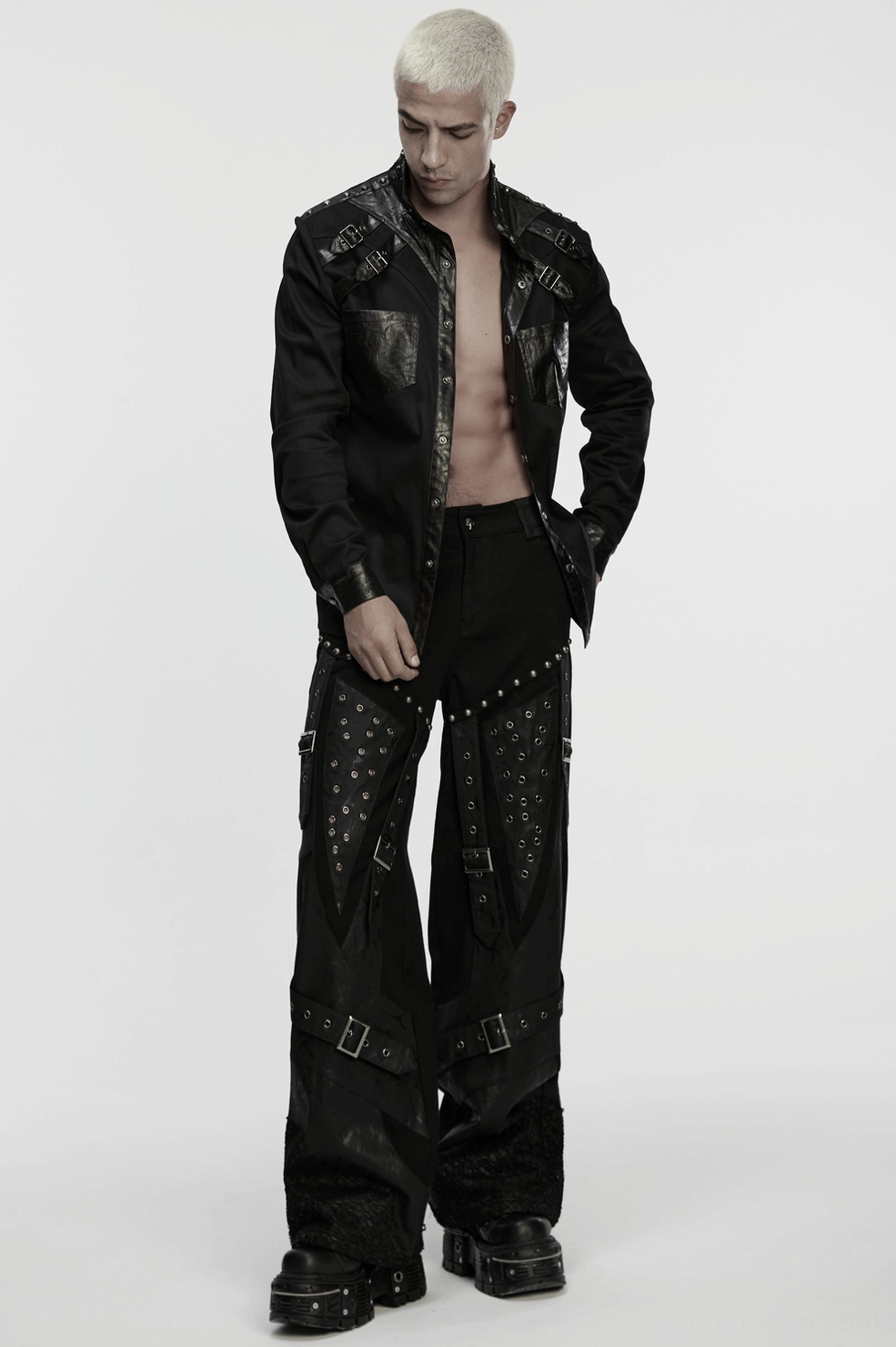 Black gothic wide-leg pants detail shot emphasizing textured embossed fabric and strap work