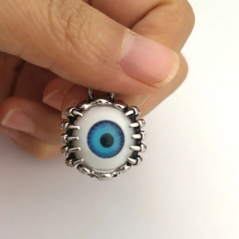 Close-up frontal view of blue eye tunnel highlighting vivid iris detail, textured spiky frame, and surgical steel quality