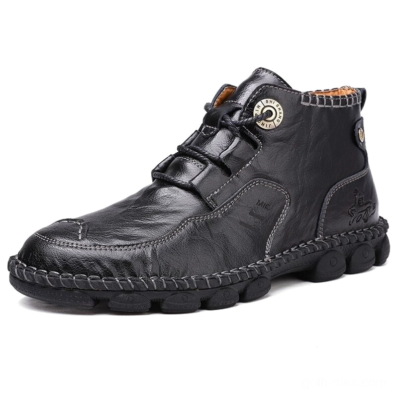 Black gothic ankle boots three-quarter front view - embossed logo accents on premium split leather
