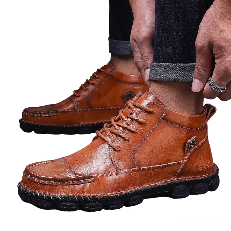 Men wearing tan gothic split leather ankle boots with rolled denim - on-foot casual wear perspective