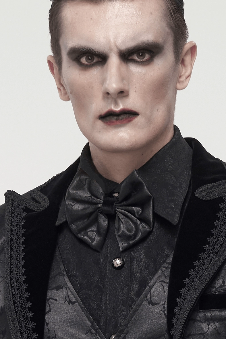 Male model close-up wearing black gothic jacquard bow tie with goth makeup and formal gothic outfit