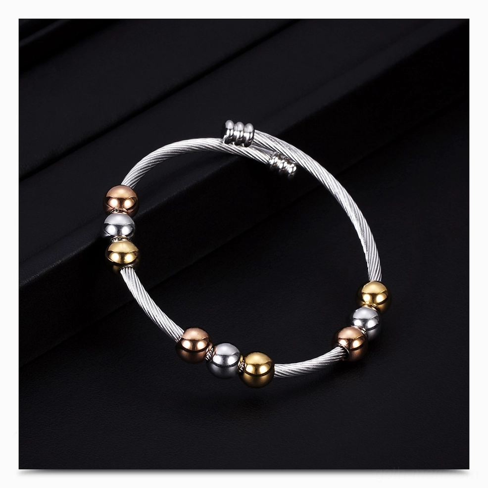 Two-tone stainless steel gothic bracelet bead pattern detail on matte black background