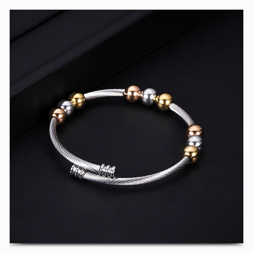 Two-tone gothic twist cuff bracelet close-up showing metal bead accents and finish