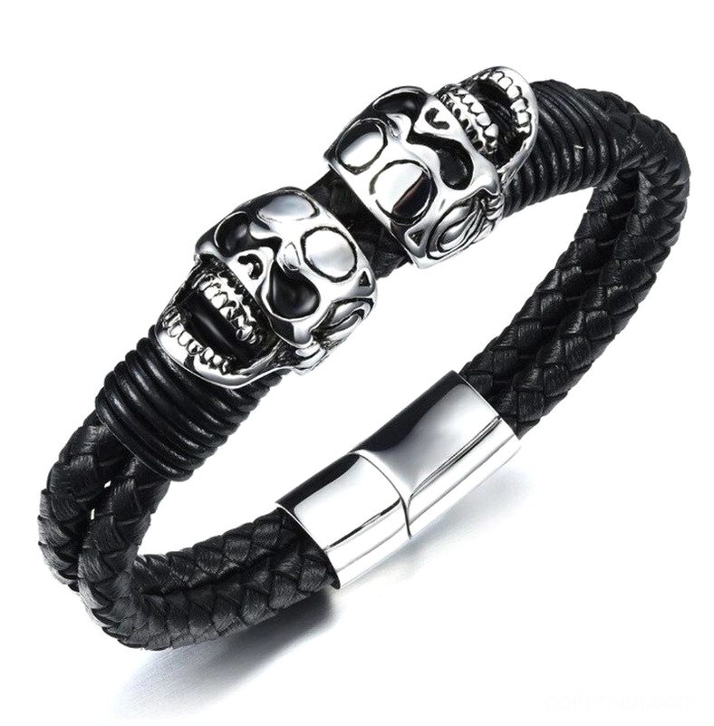 Black braided leather skull bracelet with dual stainless steel skulls, flat lay overhead view