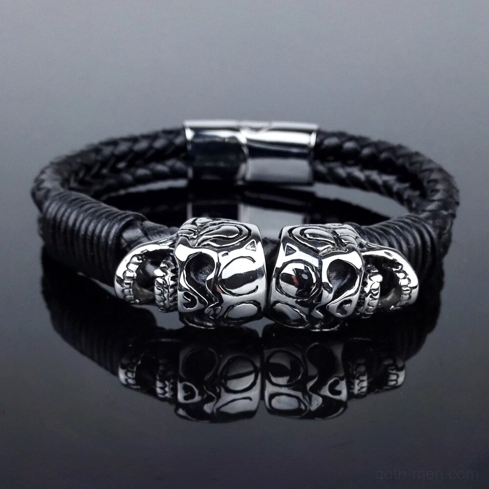 Top-down view of gothic skull bracelet with dual metal charms and toggle clasp