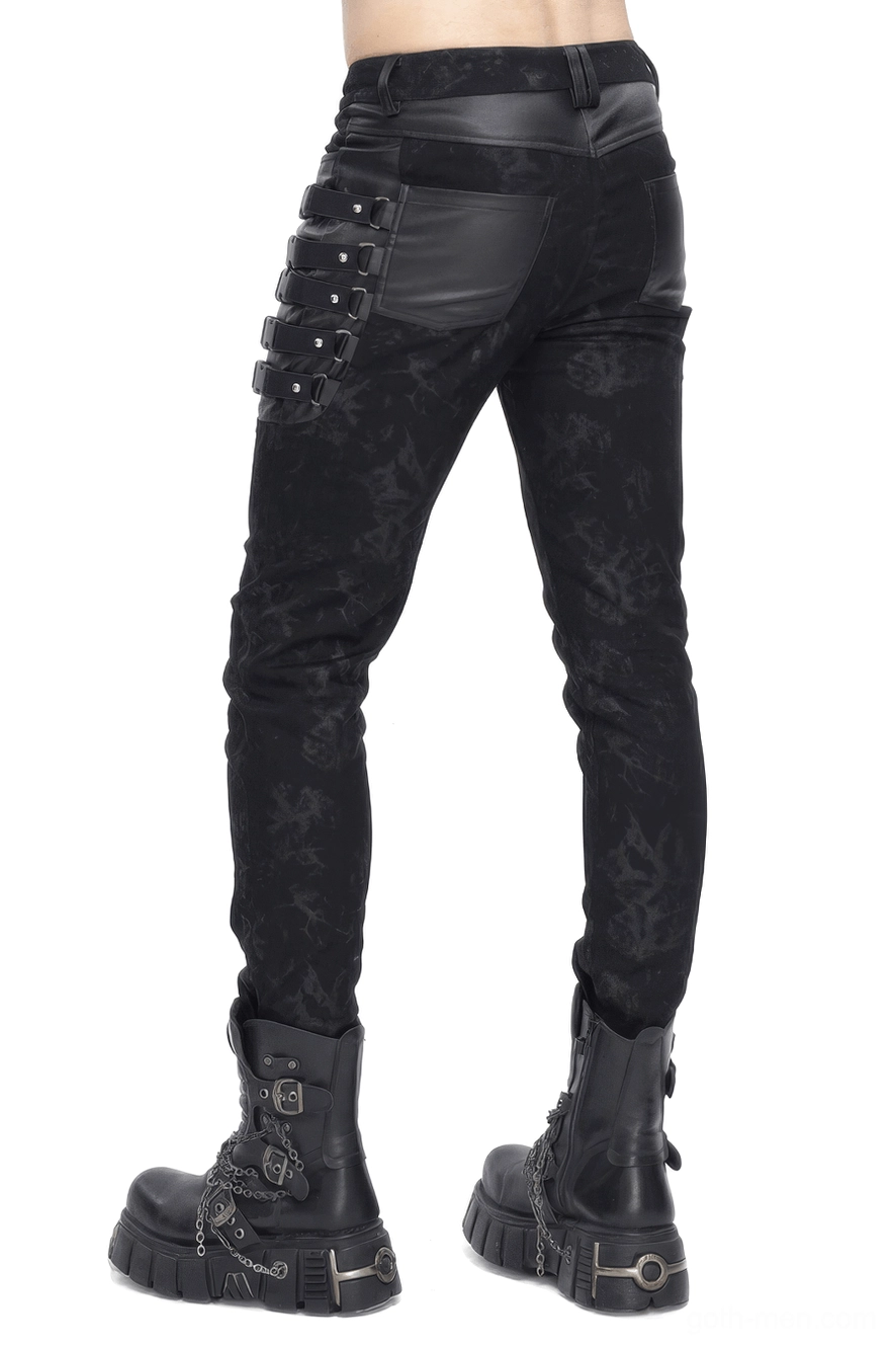 Rear three-quarter view of black gothic slim-fit trousers showing leather hip panels and back buckled strap details